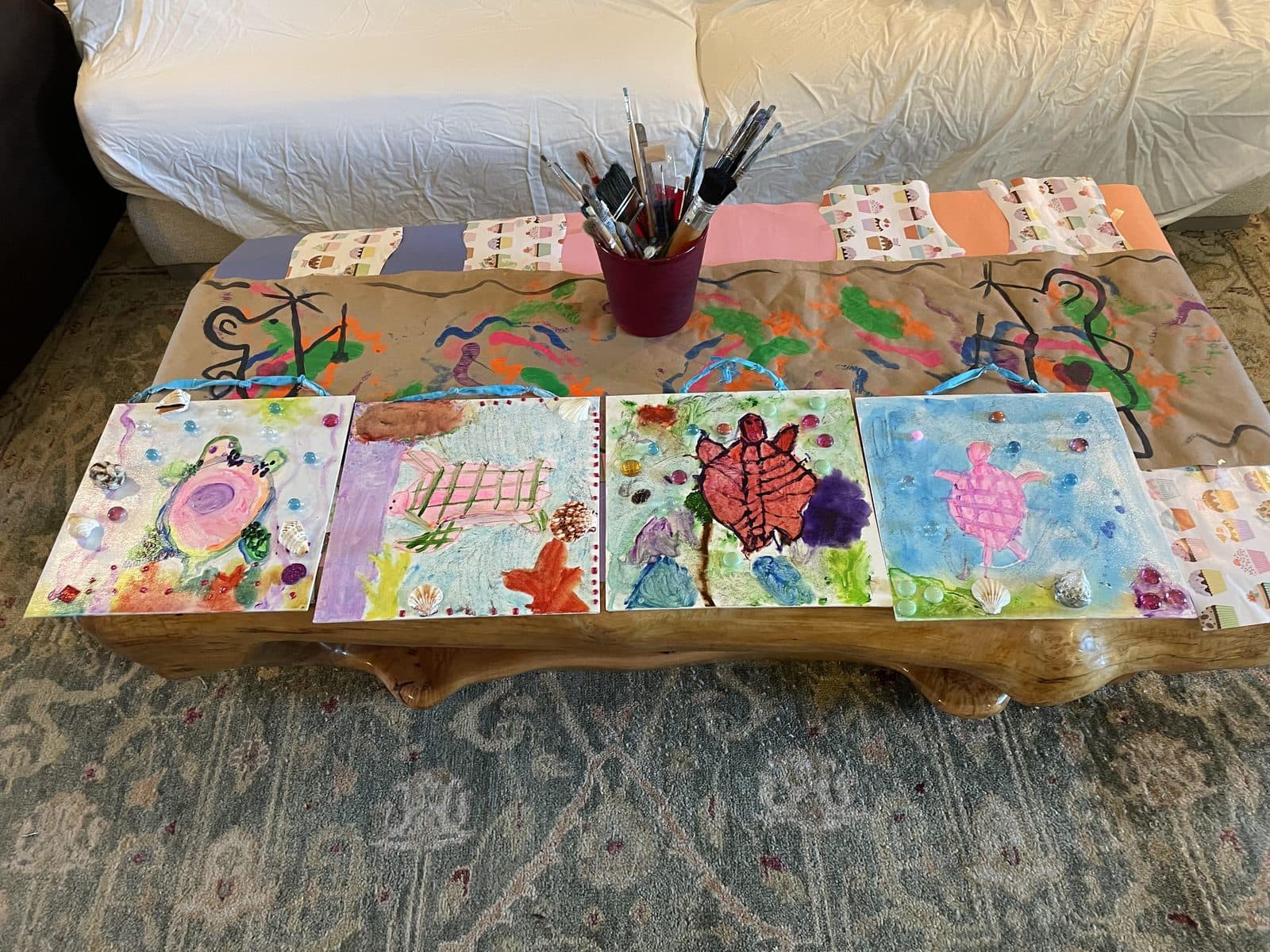 The studio table covered in works in progress