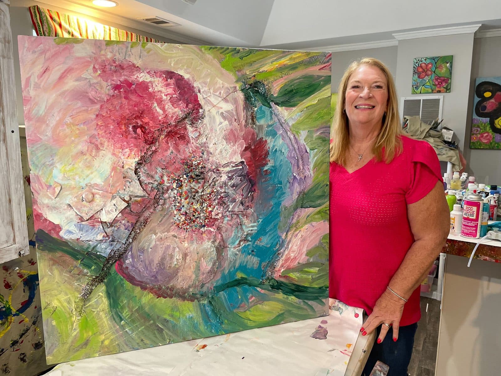 Connie and a party group in the studio with a finished painting