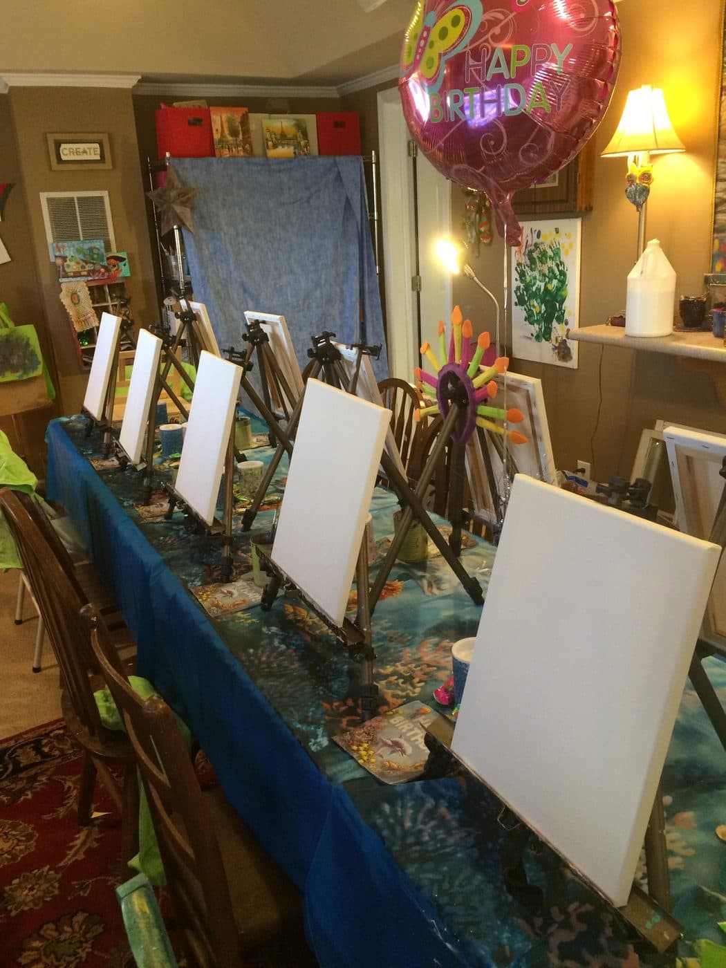 Fresh canvases lined up on easels before the guests arrive
