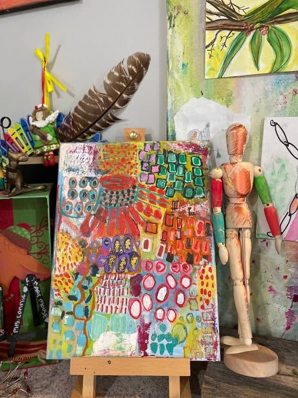 A colorful abstract resting on the studio easel