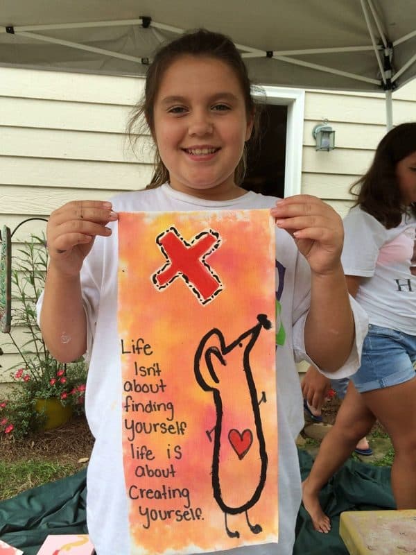 A student holding her painted banner