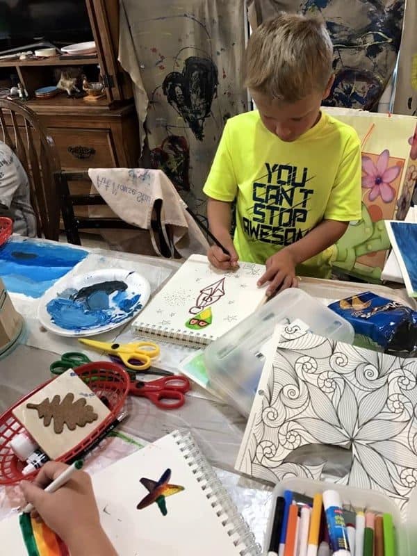 Kids sketching together at the drawing table
