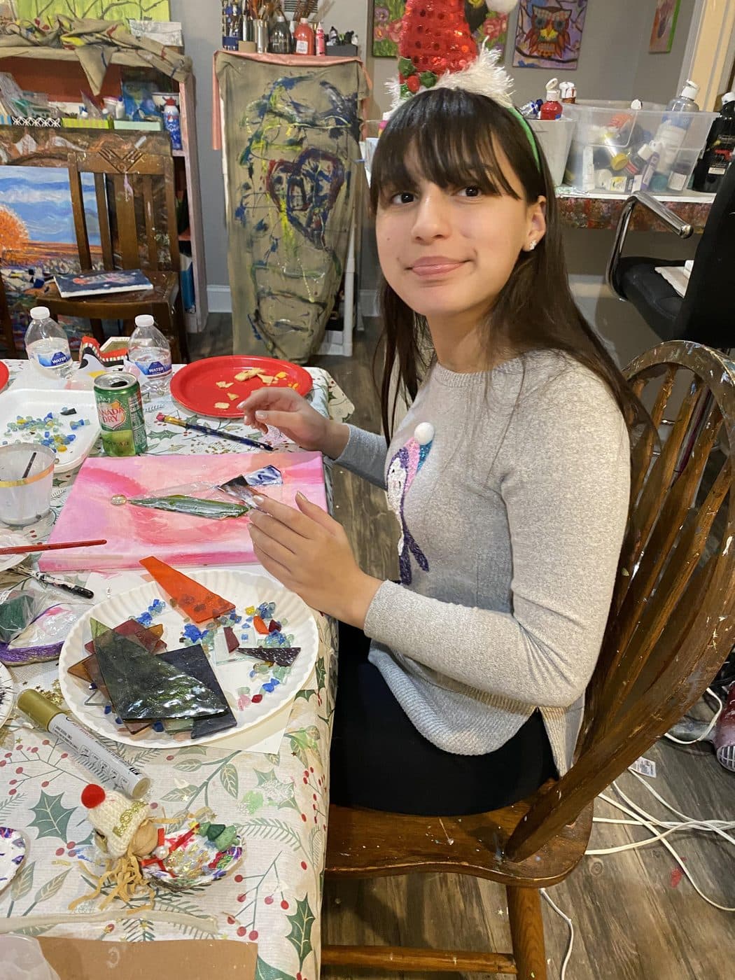 A student painting her ceramic plate